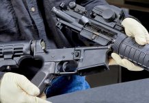 Firearms Seized Then RETURNED In Shocking Oversight Person assembling a rifle with gloved hands.