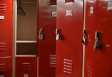 Red lockers with padlocks, one open with hanger.