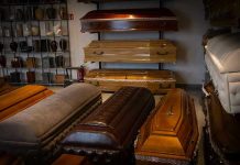 “Suicide Spike” Claim COLLIDES With Data Wooden coffins and urns displayed in a showroom.