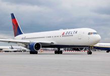 Delta Cabin BRAWL Turns Violent FAST Delta Airlines airplane on airport runway, cloudy sky.