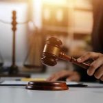 Gavel being struck near scales of justice.