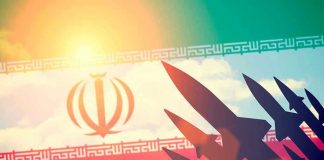 Silhouettes of missiles over Irans flag graphic.