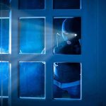 Obsessed STALKER Terrorizes BBC Anchor For YEARS Masked figure peering through glass door at night.