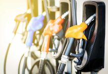 $6 Gas Claim IGNITES Washington Fight Colorful gas pump nozzles at a station.