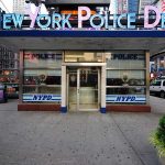 NYC Dems BLOCK Teen Shooter Arrests NYPD precinct building with signs on a city street