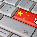 DISTURBING: China Bans Marriage Doubt Close-up of a computer keyboards enter key featuring the Chinese flag