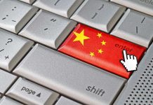 DISTURBING: China Bans Marriage Doubt Close-up of a computer keyboards enter key featuring the Chinese flag
