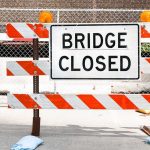 Collapsed Bridge KILLS—Google Knew For YEARS A Bridge Closed sign surrounded by safety barriers and fencing