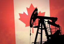 Silhouette of an oil pump jack against a Canadian flag background