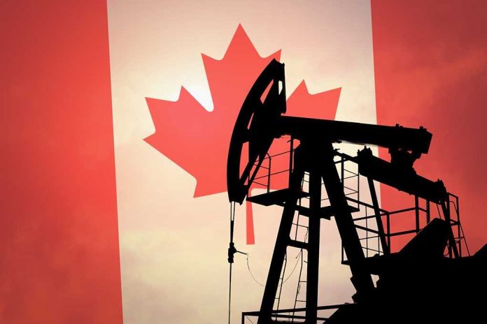 shutterstock_290285582.jpg Silhouette of an oil pump jack against a Canadian flag background