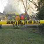 EXPLOSION ROCKS Church—Multiple Responders Down Yellow police tape marking a restricted area at a fire scene with firefighters in the background