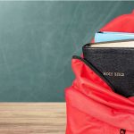 Priest’s Brazen Walmart Heist BUSTED Red backpack with a Bible and books inside.