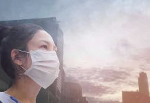 Person wearing a mask in a cityscape background.