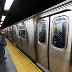 Cop Bleeding: Criminal Escapes After Brutal Assault Man waiting at subway platform with departing train.