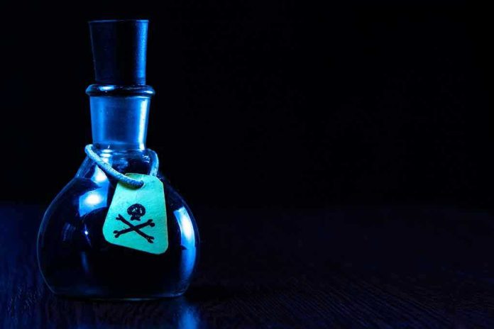 Dark bottle with skull-and-crossbones label on table.