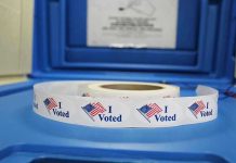 Trump FREEZES Congress Over Voting Bill Roll of I Voted stickers on table.