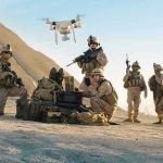 Drone Massacre EXPOSED—116 Threats Eliminated Soldiers operating a drone in a desert environment.