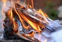 Burning papers with flames and smoke rising