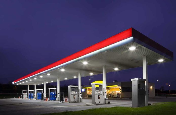 shutterstock_20633581.jpg A gas station at night with illuminated fuel pumps and a convenience store