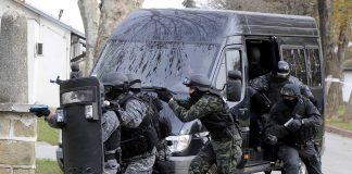 SWAT team members in tactical gear responding to a situation