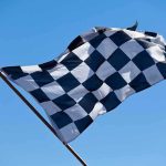 Indefinite NASCAR Ban Sparks Free-Speech Fury A checkered flag waving against a clear blue sky