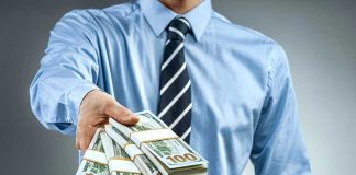 Miami’s NEW Billionaire-ONLY Commute Sparks Outrage Person handing over a stack of money.