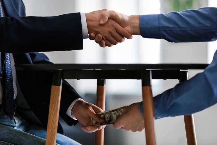 Handshake and exchange of money under the table.