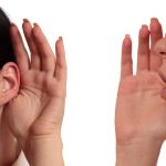 Person whispering into another persons ear gesture