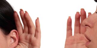 Person whispering into another persons ear gesture