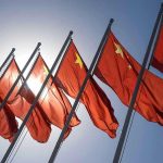Red flags with yellow stars on flagpoles.