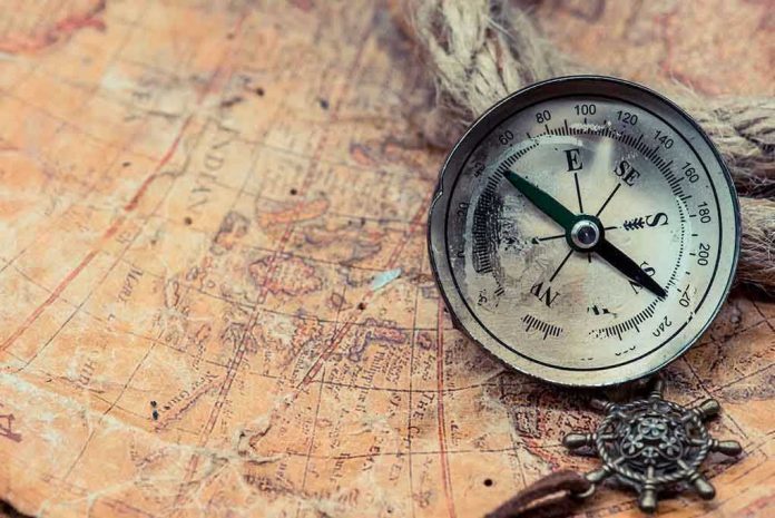Old compass on a vintage map background.