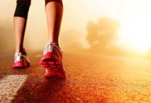 Person jogging on a road during sunrise