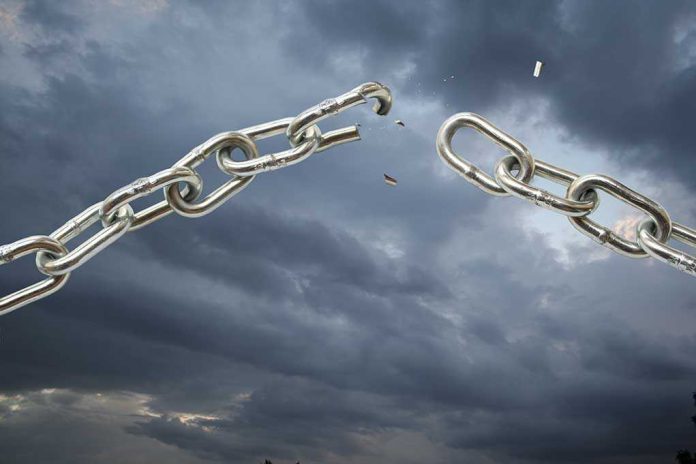 shutterstock_17445256.jpg A broken metal chain against a stormy sky
