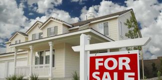 Germany’s Homebuying SHOCK—Politics Checkpoint A suburban house with a For Sale sign in the front yard