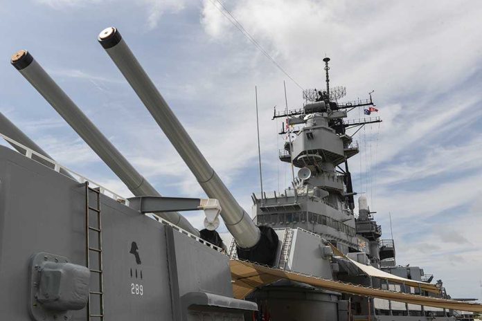 Close-up of a battleships naval guns and superstructure against a cloudy sky