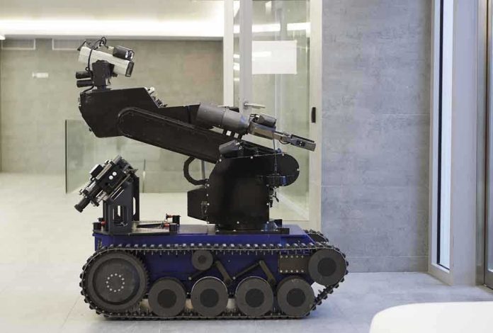 A robotic arm mounted on a tracked base in a modern workspace