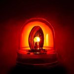 Officer DOWN—Rural Town LOCKED in Terror Red emergency light illuminated against a dark background