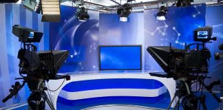 Tech Company Forces ESPN Bloodbath A television studio setup with cameras and a blue backdrop
