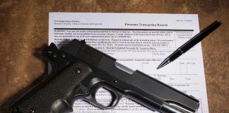 Gun and pen on firearm transaction form.