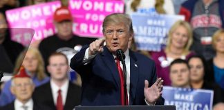 Bond Market WARNING Shakes Washington! Person speaking at rally with crowd behind podium