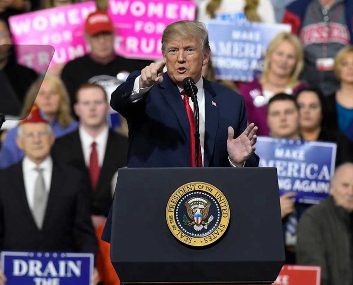 1046190946-1 Person speaking at rally with crowd behind podium