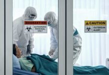 Deadly Virus Ship Chaos Uncovered Healthcare workers in protective gear in quarantine room.