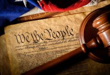 Citizenship Clause: Supreme Court’s Ticking Time Bomb Gavel on U.S. Constitution with flag backdrop.