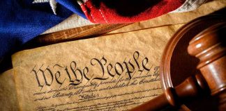 Citizenship Clause: Supreme Court’s Ticking Time Bomb Gavel on U.S. Constitution with flag backdrop.