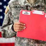 Pentagon UFO Files Released: Decades of Mystery Unveiled Soldier holding red top secret file folder.