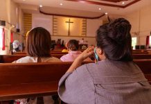 Vatican Unveils LGBTQ+ Report—Conservatives Outraged! People sitting in church pews during service.