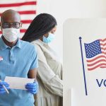 Supreme Court Ruling Shakes Voting Rights People voting with masks and gloves at polling station.