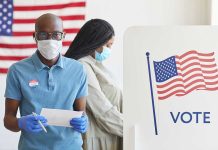 Supreme Court Ruling Shakes Voting Rights People voting with masks and gloves at polling station.