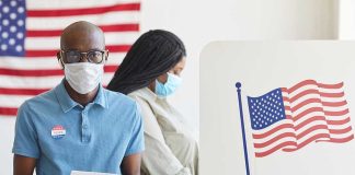Supreme Court Ruling Shakes Voting Rights People voting with masks and gloves at polling station.