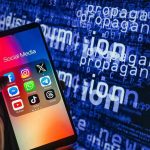INSULT DEBATE: When Does Rhetoric Turn ‘Violent’? Smartphone showing social media apps with text background.